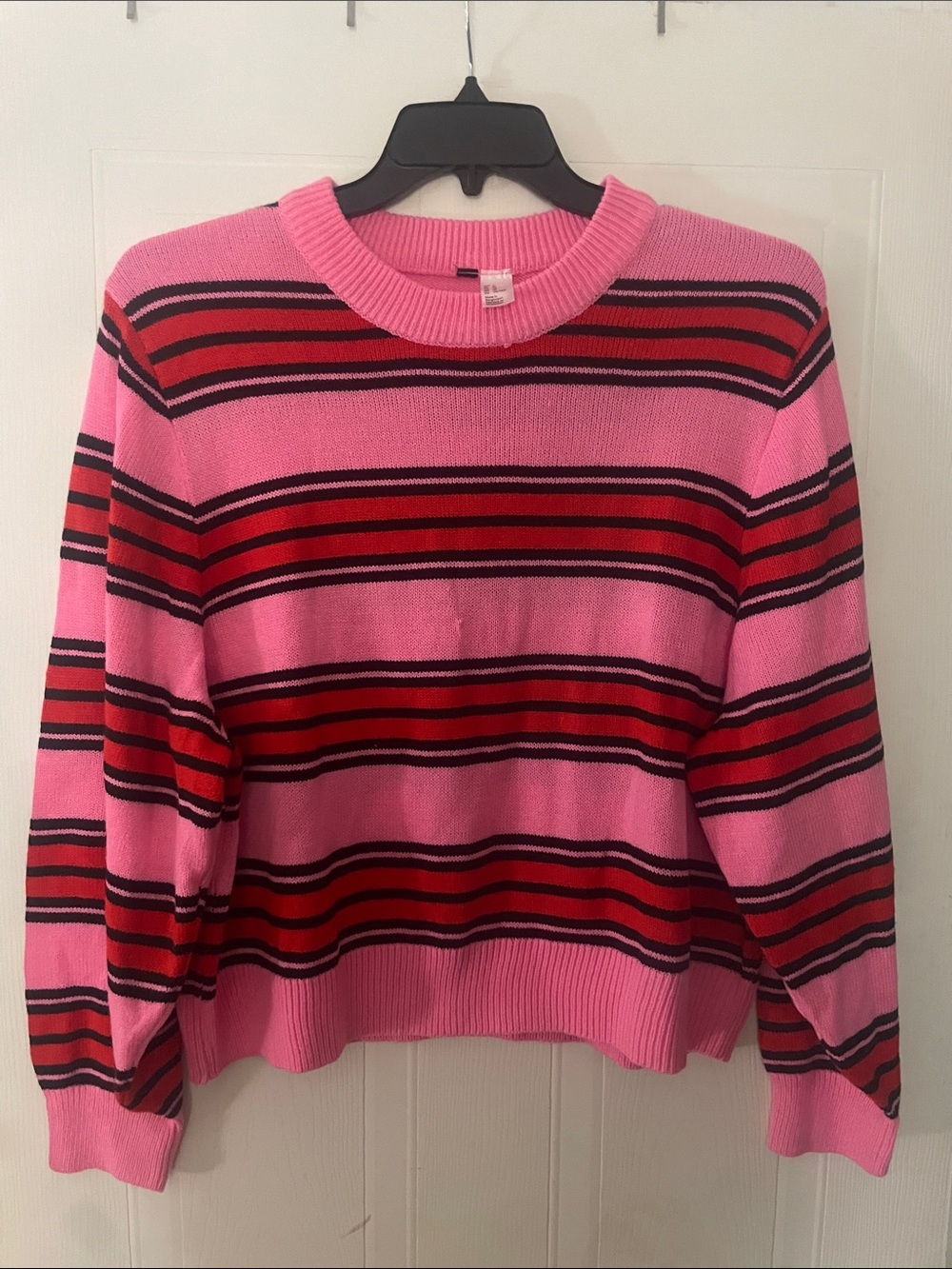 Really cute pink with black and red stripes that run horizontal sweater.